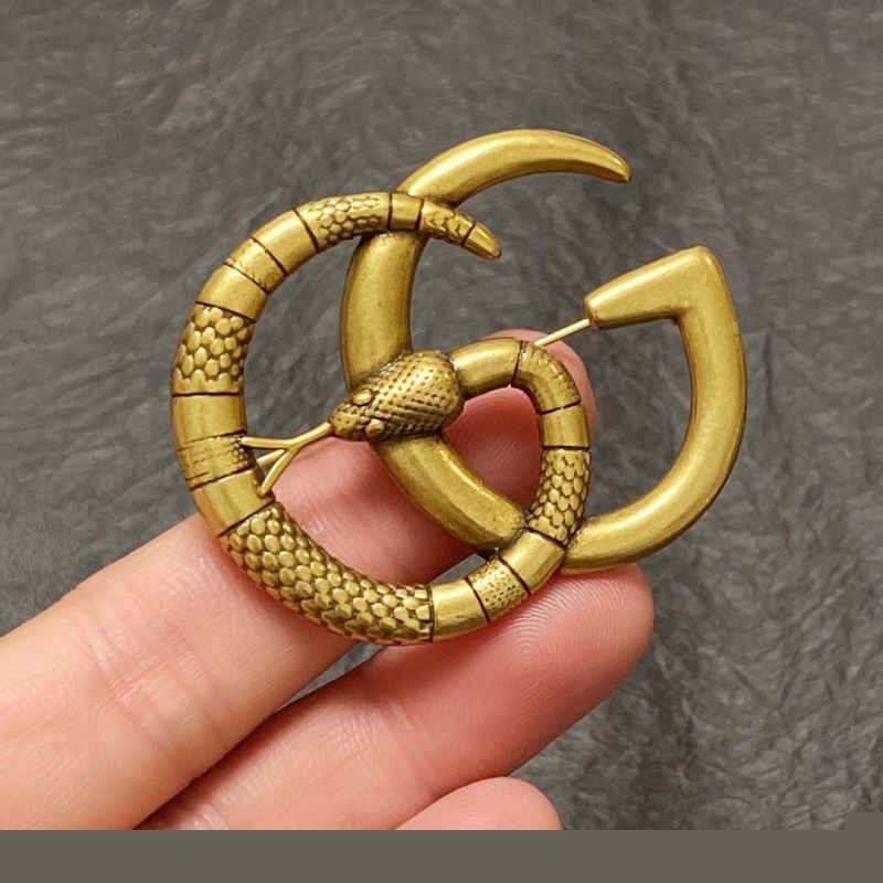 G*u*i brooches
